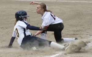 Holy Names third baseman Riley Hughes tags out courtesy runner Sarah Muir at third during the Metro League Championship game Friday at Lower Woodland in Seattle. Bainbridge lost to the Cougars 6-4.