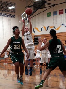 BHS senior guard Paige Brigham takes a shot late in the first quarter of Wednesday's game against Franklin High. The varsity girls basketball team plowed through their opponent from Seattle