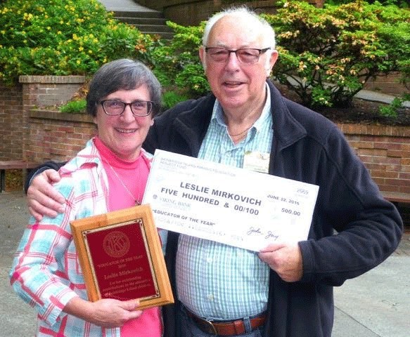 Leslie Mirkovich stands with Kiwanis Club President John Jay