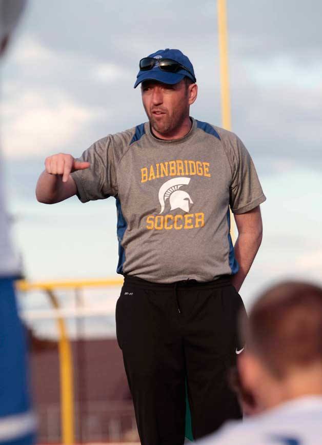 Spartan Head Coach Ian McCallum talks with the BHS varsity boys soccer team during half time at last Thursday's match against Rainier Beach.