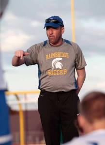 Spartan Head Coach Ian McCallum talks with the BHS varsity boys soccer team during half time at last Thursday's match against Rainier Beach.