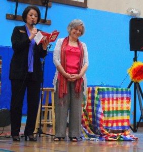 District Superintendent Faith Chapel reads from a children's book at the start of her complimentary comments on Catherine Camp