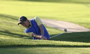 Senior Kyle Leonard chips a shot onto the green on the ninth hole at Wing Point Wednesday. Bainbridge defeated O'Dea 141-137.