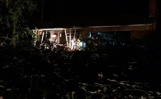 Firefighters make sure a fire at a Marshal Road home is fully extinguished late Monday night.