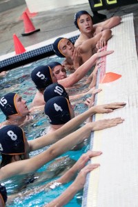 The Spartans regroup during a time out at a recent match. The team will advance to the State playoffs later this week