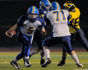 Bainbridge quarterback Chris Bell looks for running room during a district playoff game at Bellevue on Friday. The Spartans were eliminated by the two-time defending champs 54-7.