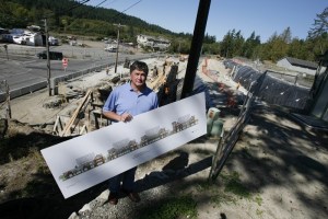 Developer Bill Nelson holds up a development sketch in June 2008 as Rich Pass LLC prepared for constructing four large buildings on the space behind him.