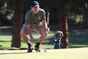 Spartan golfer Garrett Aichele lines up a put during last week’s home match against the Crusaders.
