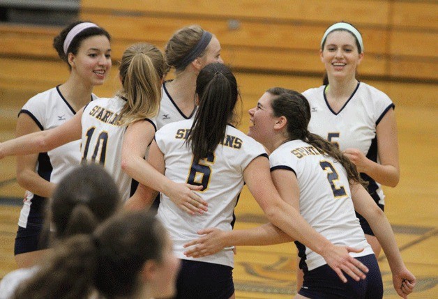The Spartans happily huddle during a rally against Lakeside.