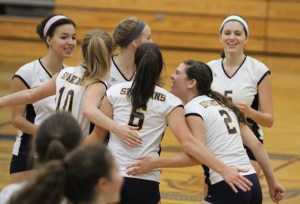 The Spartans happily huddle during a rally against Lakeside.