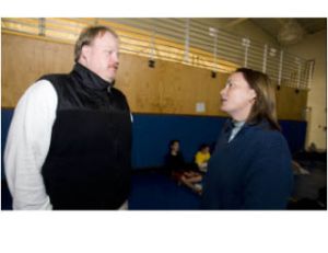 Athletic Director Annette Duvall and varsity football coach Andy Grimm discuss an issue during a weight management class at Bainbridge High School.