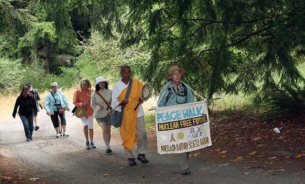 A group of walkers head toward downtown Winslow during the annual Nipponzan Myohoji Peace Walk.