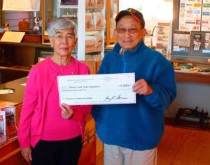 Tomi and Henry Egashira display their big payout after winning the grand prize in this year’s museum raffle.