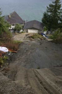 The first (above) of two mudslides that covered Gertie Johnson Road and threatened homes occurred late Sunday