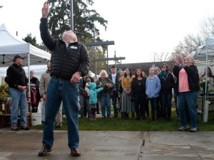 Bainbridge Island Mayor Val Tollefson kicks off the farmers market opening day festivities with the traditional cheese toss