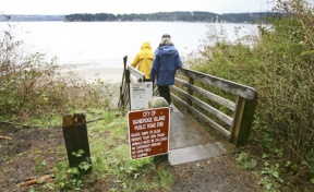 Neighbors descending a staircase at the Hidden Cove road end. Public vehicular access to the top of the bluff could be lost if the city and a private developer agree to controversial improvements there.