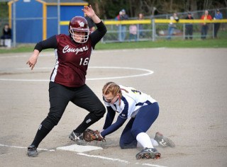 Bainbridge fastpitch player Hailey Willmann attempts a tag at first base during home action against Holy Names Wednesday.