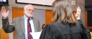 New Bainbridge Councilman Val Tollefson takes the oath of office.