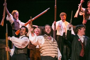 Pictured are students at the barricade in Ovation! Musical Theatre Bainbridge’s new production of “Les Misérables.” The show runs through July 7. From left to right are Michael Renney as Joly