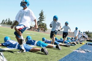 Bainbridge Spartan freshmen players (running in white shirts) take part in aerobic drills with the more senior team members (on the ground
