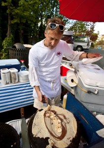 J’aime Les Crepes owner Paul Pluska cooking for visitors to the Bainbridge Island farmers market outside of his new Madrone Lane shop location.