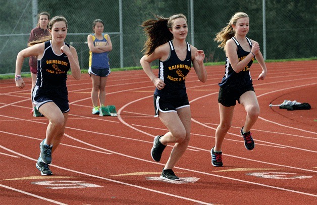 Spartan freshman sprinters Jessica and Nicole Vadez and teammate Lucy Donohue run in the 100-meter during last week’s meet.