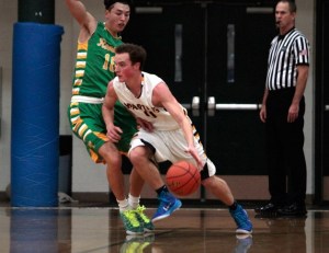 Spartan senior guard Reed Thomas drives around Roosevelt’s defenses Tuesday.