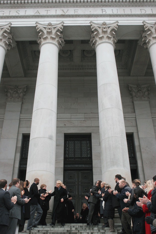Christine Gregoire shakes hands with government employees as she leaves the Legislative Building in Olympia Wednesday after Jay Inslee's swearing-in ceremony as Washington's governor.
