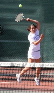 Sammi Jiang of Bainbridge returns a shot in action against Anya Renkes of Holy Names.