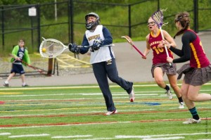 Bainbridge goalkeeper Maddy Stevenson passes the ball to a teammate with Rebecca Long (10) and Jade Blake-Whitney of Lakeside in pursuit. Stevenson had nine saves in the Spartans’ 16-8 win over the Lions Saturday at Eastside Catholic High School.