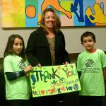 Photo courtesy of Liam McEvilly                                Boys & Girls Club kids thank Puget Sound Energy 
outreach manager Karen Brubeck for the company&rsquo;s $5,000 donation.