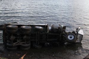 Truck driver misses curve, flips truck onto South Beach