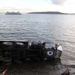 Truck driver misses curve, flips truck onto South Beach