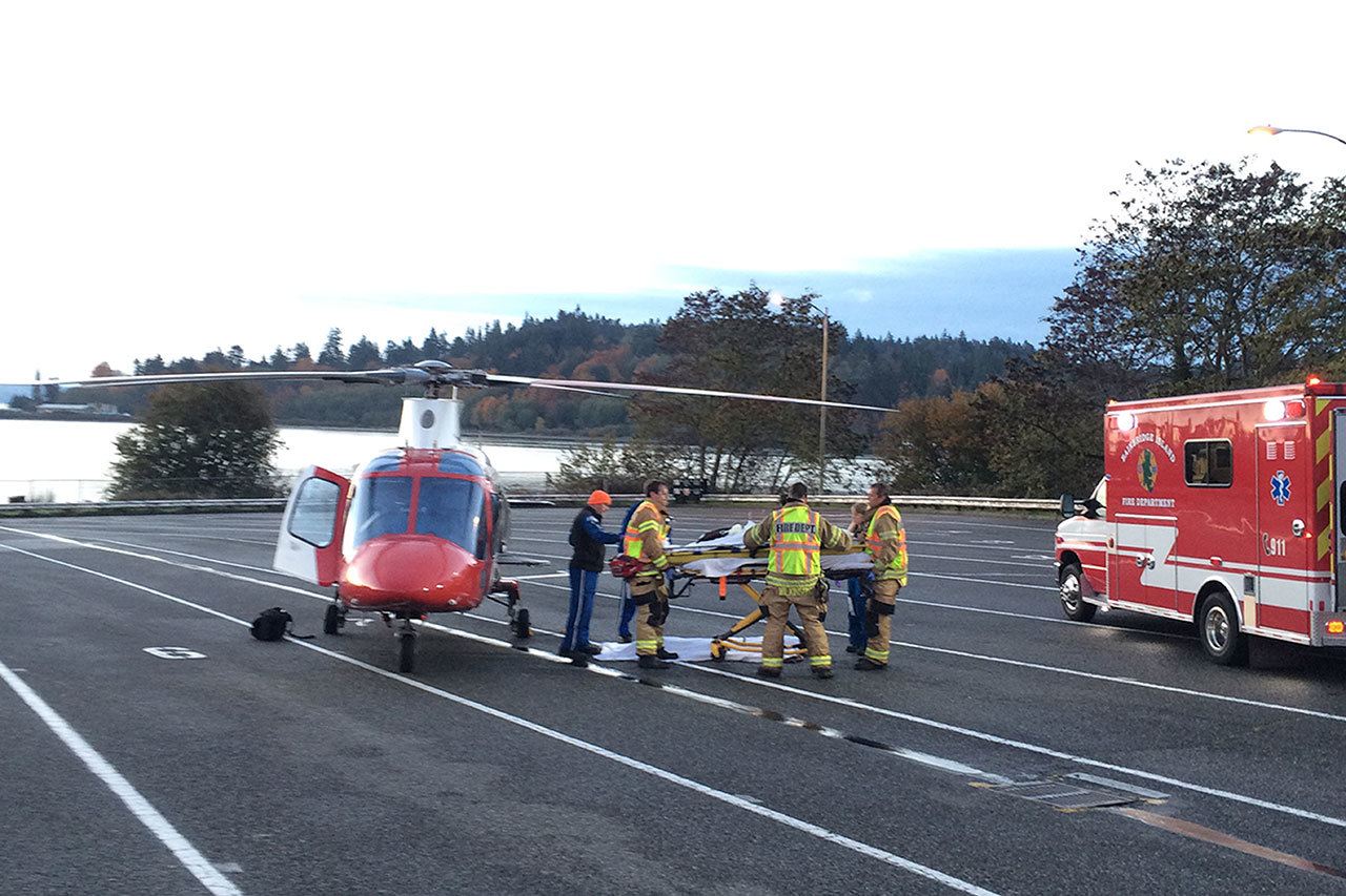 Image courtesy of the Bainbridge Island Fire Department Three people were hurt after a 1994 Dodge Caravan careened off the road just before 7 a.m. Sunday, Oct. 30 and landed in the woods just north of the Bainbridge ferry terminal, including the driver who was air lifted to a Seattle hospital.