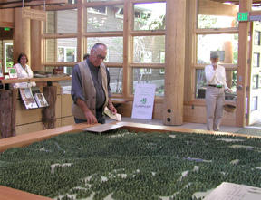 Zalmai “Zeke” Zahir inspects a topographical model of the IslandWood grounds during grand-opening festivities Saturday.
