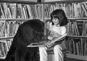 St. Cecilia second-grader Elena Rowe reads to Arayo.