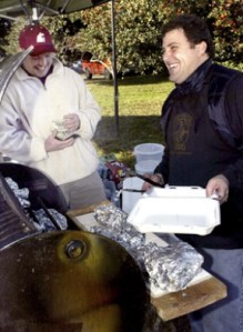 Bainbridge Island Barbeque was recently launched by owner Gregory Epstein (at right dishing up barbecue) at the winter farmers market on Saturday.