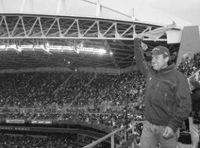 Bainbridge Island resident and noted mountaineer Ed Viesturs gets the crowd pumped up after raising the “12th man” flag at Qwest Field