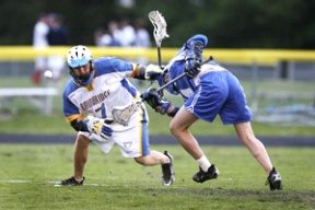 Bainbridge’s Clayton Knight fights with a Curtis defender for the ball in last Thursday’s game. The senior midfielder scored a goal as he helped the Spartans defeat the Vikings 18-6 last Saturday.