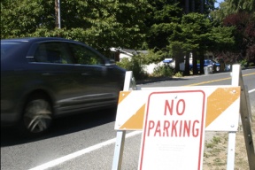 A "No Parking" sign sits on Grow Avenue. The City Council rejected a $450