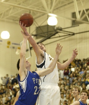 Theo Miller skies for a rebound against Seattle Prep’s CJ Cullen.