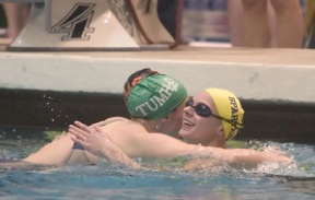 Tumwater’s Karlyn Hougan and Centralia’s Amelia Messegee hug Anne Scott after her victory