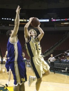 Chris Kelly goes to the rack in the Spartans’ varsity basketball game against North Kitsap Monday afternoon at Key Arena in Seattle