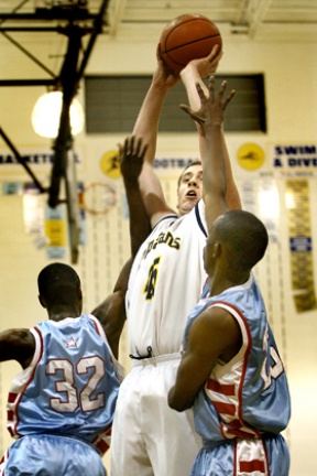 Bainbridge’s Coby Gibler shoots over Chief Sealth’s Michael Timmons (left) and Nyandigisi Moikobu in the Spartans 61-50 win Tuesday.