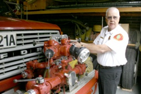 Volunteer assistant chief Ken Beach of the Bainbridge Island Fire Department explains the workings of the water pump on one of the department’s older trucks.