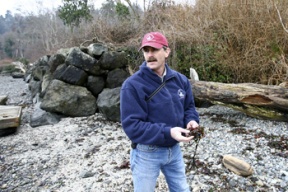 Marine habitat specialist Jim Brennan finds a patch of beach ideal for fish habitat and marine plants just beyond the reach of a rip rap bulkhead on Blakely Harbor’s southeast shore.
