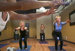 A YogaCore class led by Katie Pearson (off camera) at Be New yoga studio in Winslow Green assumes the “chair” pose.