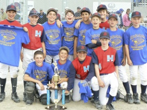 Members of the Bainbridge Hurricanes 12U team pose with their trophy after winning the first annual BlueJackets Invitational tournament at Fairgrounds Field in Silverdale in July.