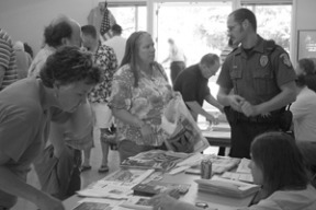 (Top) BIPD Marine Patrol officer Ben Sias chats with several people as they gather info on boat safety at the first annual Coast Guard Auxilary Boating Fair held at the Bainbridge Commons on Saturday. More than 140 people attended the event.