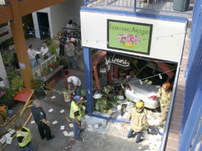 An 81-year-old Bainbridge man escaped serious injury Tuesday afternoon when he crashed his car through the Flowering Around storefront at Winslow Mall. No pedestrians or employees were injured in the crash